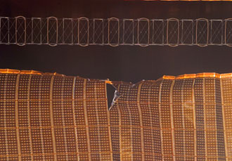 STS-120 Flight Day 8: A view of a damaged P6 4B solar array wing on the International Space Station. Image credit: NASA TV 